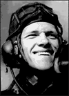 Black-and-white portrait of a smiling World War II pilot wearing a flight helmet and radio headset, looking upward with sunlight on his face.