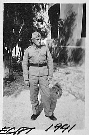 A man in a military uniform stands outdoors near trees and a building. The handwritten text at the bottom reads "EGYPT 1941.