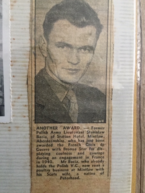 Black-and-white newspaper cutting of a man in a suit with text below describing his military honours and current occupation in Mintlaw, Aberdeenshire.