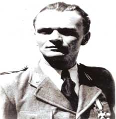 Black and white photo of a man in a military uniform, wearing a medal and looking slightly to the side.