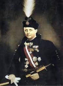 A man in formal military uniform with medals, a sash, and a feathered hat holds a sword and looks towards the viewer against a dark background.