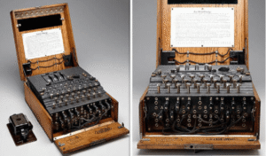Two views of a vintage Enigma machine with wooden casing, showing its keys, dials, internal wiring, and an instruction sheet inside the lid.