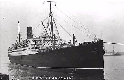 Black-and-white photo of the RMS Franconia, an ocean liner, berthed or near shore with its name visible on the bow.