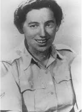 Black-and-white photo of a woman with short dark hair, wearing a buttoned-up collared shirt, looking at the camera and smiling.
