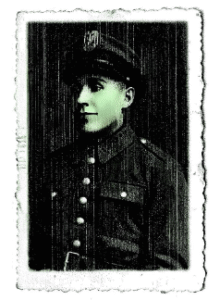 Black and white portrait of a uniformed soldier wearing a cap, facing slightly to the side. The photo has a decorative, worn border.