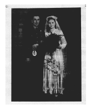 A black-and-white photo of a bride in a traditional gown and veil standing next to a groom in uniform, likely on their wedding day.