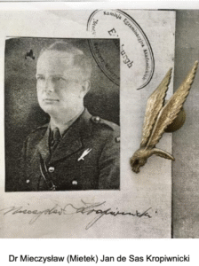 Black-and-white portrait of a man in military uniform on a document, next to a winged badge and handwritten signature.
