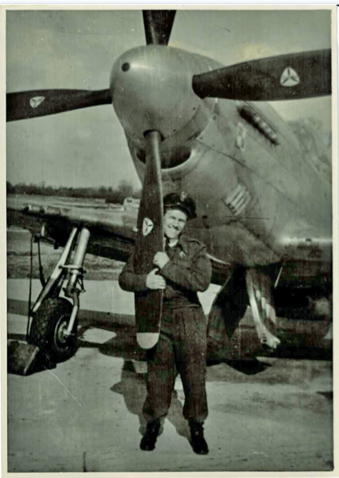 A pilot hugging the propellor of a Mustang aircraft