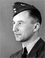 A man in a military uniform and cap poses for a formal portrait, facing slightly to the right against a plain background.