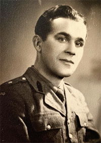 Black and white portrait of a man in a military uniform, facing the camera with a neutral expression.