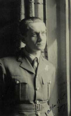 A man in a military uniform stands by a window, looking outside. The photo is black and white and appears to be dated October 1941.