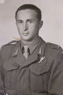 A young man in a military uniform poses for a formal black-and-white portrait.