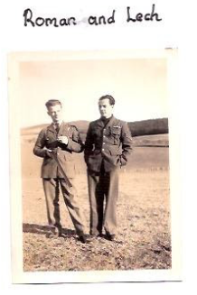 Two men in military uniforms stand outdoors in a field with distant hills. Handwritten text above the photo reads "Roman and Lech.